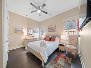 a bedroom with a bed and a ceiling fan at Blue Snapper condo in Carolina Beach