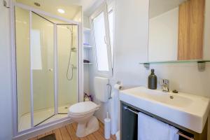 a bathroom with a toilet and a sink and a shower at Mobile home Adria in Murter +23 photos