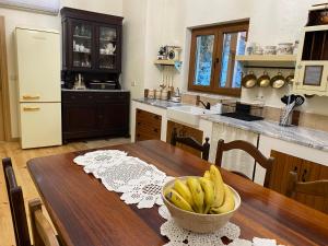 a kitchen with a table with a bowl of bananas on it at Riba Loivos Village - Casa C - T3 in Casal de Loivos