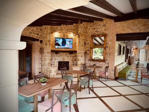 a dining room with tables and chairs and a fireplace at La Quinta Luxury Palace in Arnuero