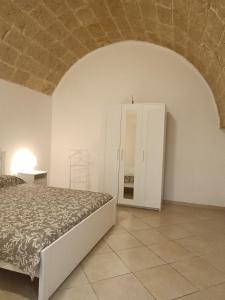 a bedroom with a bed and a white cabinet at Pascasio17 in Mola di Bari