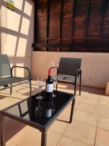 a bottle of wine and a glass on a table at Villa Punta Calma in Majanicho