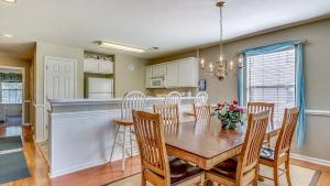 a dining room and kitchen with a table and chairs at 57C Fifty-Seven Sea at True Blue condo by Peace Vacations in Pawleys Island +16 photos