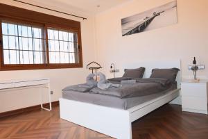 a bedroom with a bed in a room at Precioso Chalet - Piscina- Garaje privado- Jardín in Marbella +75 photos