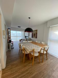 a dining room with a table and chairs at Dpto Frente al mar Av Bunge y Av Del Mar in Pinamar