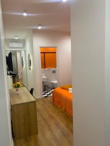 a bedroom with an orange bed and a bathroom at Vere Side Hotel in Tbilisi City
