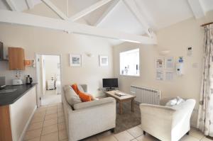 a living room with two chairs and a table at Dairy Cottage in Shaftesbury