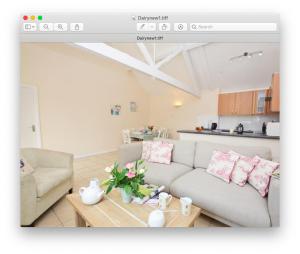 a living room with a couch and a table at Dairy Cottage in Shaftesbury