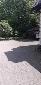a shadow of a building on a brick patio at Zajazd Stok in Górecko Stare +43 photos
