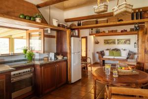 a kitchen with a table and a dining room at Casa Amanecer in Haría