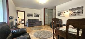 a living room with a couch and a table at VIP Apartamenty Sienkiewicza in Zakopane