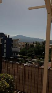 a view of a city with buildings and a fence at Home Fiesta in Giardini Naxos