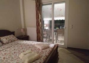 a bedroom with a bed with two towels on it at Villa Krina Rosa Aigio in Elíki