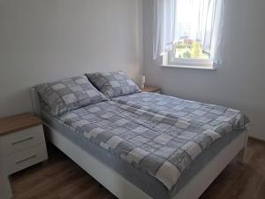 Postel nebo postele na pokoji v ubytování Domki Letniskowe Aleksandra