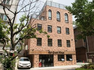 a brick building with a car parked in front of it at Roi Guesthouse in Seoul