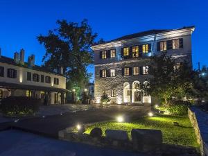 a building with lights in front of it at night at Despotiko in Portari&aacute;