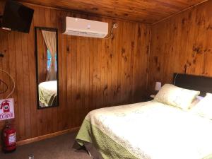 Postel nebo postele na pokoji v ubytování Refugio del Chucao Chiloe