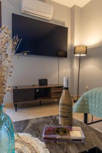 a bottle of alcohol sitting on a table in a living room at Lixourious Apartment in Lixouri