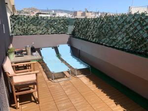 two blue chairs and a table on a balcony at MARGARITA'S SUITES in Athens