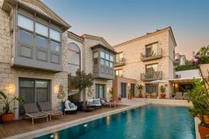 an exterior view of a house with a swimming pool at Muse Alaçatı in Alacati