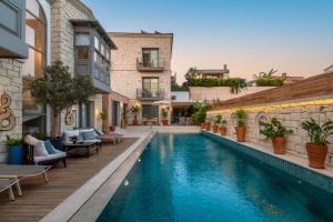 a swimming pool in the middle of a building at Muse Alaçatı in Alaçatı