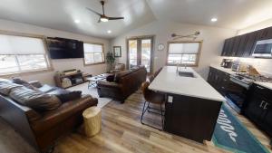 a kitchen and living room with a couch and a table at Red River Retreat - WiFi - Hot Tub - Fireplace - Washer - Dryer - Grill in Red River