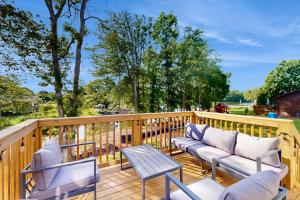 a deck with two chairs and a table at Pebble Point Cove in Salisbury