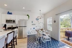 a kitchen with a table and a refrigerator at Pebble Point Cove in Salisbury