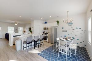 a kitchen and dining room with a table and chairs at Pebble Point Cove in Salisbury