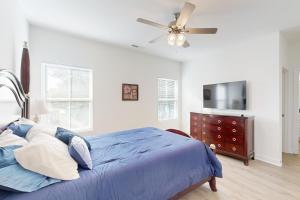 a bedroom with a blue bed and a ceiling fan at Pebble Point Cove in Salisbury
