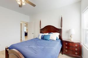 a bedroom with a bed with blue sheets and a dresser at Pebble Point Cove in Salisbury