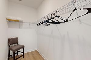 a room with a chair and a rack of shoes at Pebble Point Cove in Salisbury