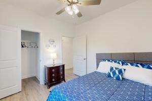 a bedroom with a blue bed and a ceiling fan at Pebble Point Cove in Salisbury