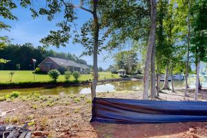 a blue hammock on the ground next to a pond at Pebble Point Cove in Salisbury