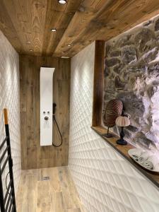 a room with a wall with a stone wall at l atelier in Bozel