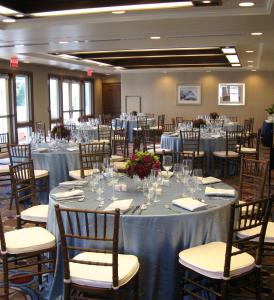 a room filled with tables and chairs with tablesktop at Inn By the Sea in Cape Elizabeth