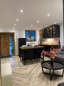 a kitchen and living room with a couch and a table at l atelier in Bozel +19 photos