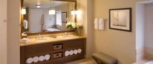 a bathroom with two sinks and a large mirror at Inn By the Sea in Cape Elizabeth