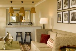 a living room with a couch and a kitchen at Inn By the Sea in Cape Elizabeth