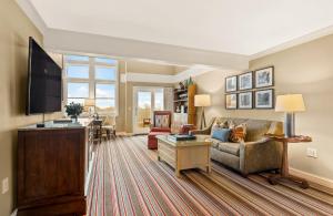 a living room with a couch and a tv at Inn By the Sea in Cape Elizabeth