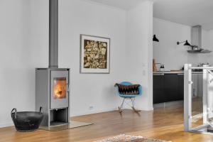 a living room with a wood burning stove in it at Funkisvilla med panoramautsikt in Tromsø