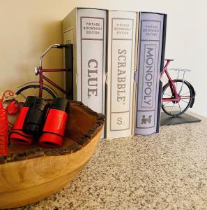 a wooden bowl with books next to a bike at Inn By the Sea in Cape Elizabeth