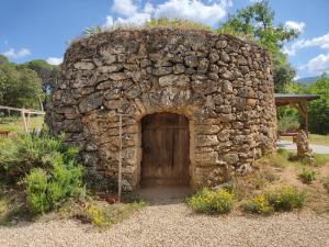 a stone building with a door in the middle at Villa dans la forêt provençale in Jouques