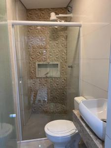 a bathroom with a shower with a toilet and a sink at Estação Sé Hotel in Sao Paulo