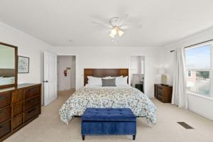 a bedroom with a bed and a ceiling fan at Bliss by the Bay in Panama City