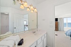 a bathroom with a sink and a large mirror at Bliss by the Bay in Panama City +31 photos