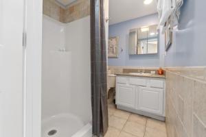 a bathroom with a shower and a sink at Beachside Bliss in Saint Augustine +22 photos