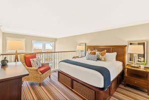 a bedroom with a bed and a balcony at Inn By the Sea in Cape Elizabeth