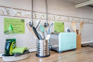 a kitchen counter with a container of kitchen utensils at On the way!* in Portimão