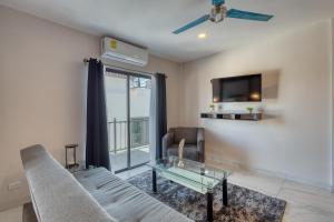 Una sala de estar con un sofá y una mesa de cristal. en Princess 805 at Morgan Residences, en Cabo San Lucas